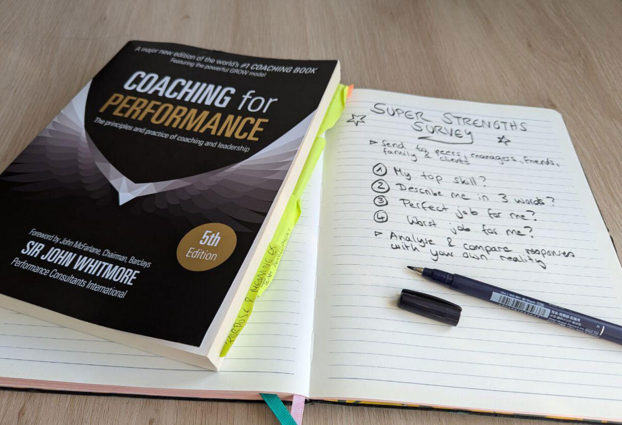 Photo of the book "Coaching for Performance", next to notes taken by myself about a super strengths survey Photo of the book "Coaching for Performance", next to notes taken by myself about a super strengths survey