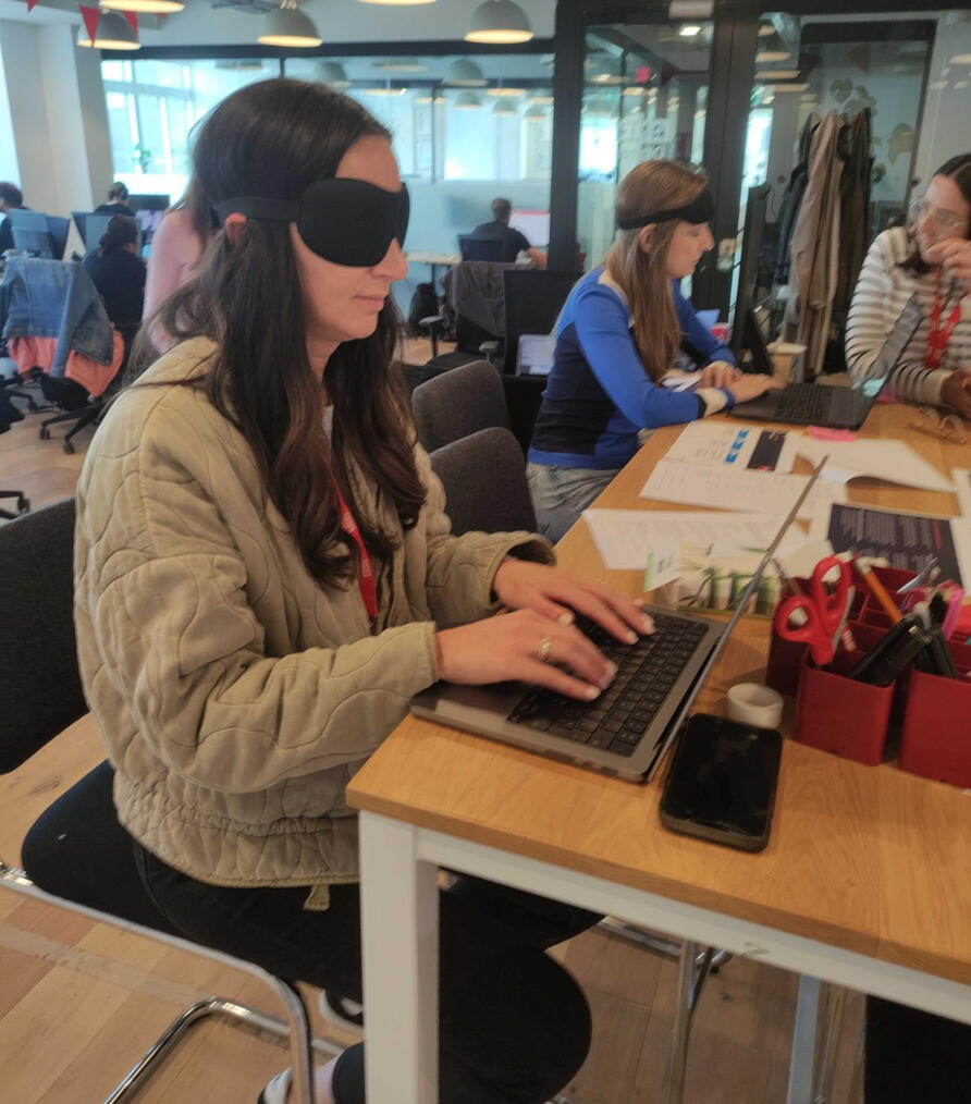 Photo of participants wearing blindfolds at the Accessibility Empathy Lab while using a screen reader